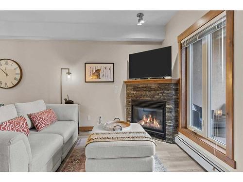 204-155 Crossbow Place, Canmore, AB - Indoor Photo Showing Living Room With Fireplace