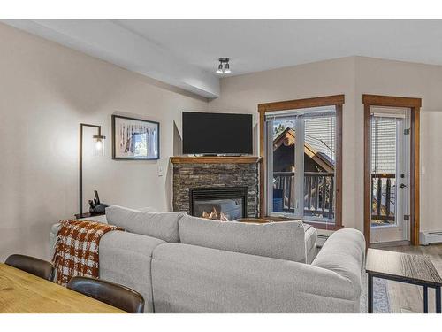 204-155 Crossbow Place, Canmore, AB - Indoor Photo Showing Living Room With Fireplace