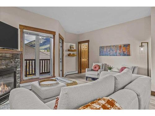 204-155 Crossbow Place, Canmore, AB - Indoor Photo Showing Living Room With Fireplace