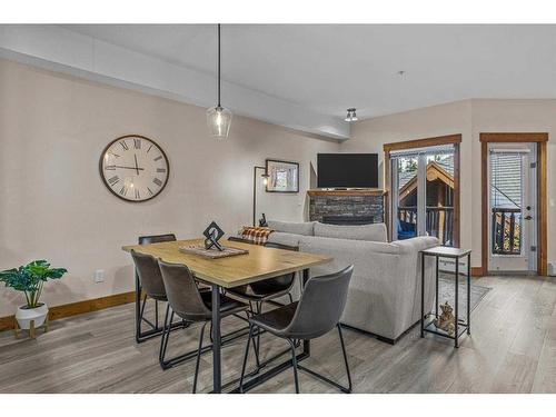 204-155 Crossbow Place, Canmore, AB - Indoor Photo Showing Dining Room With Fireplace