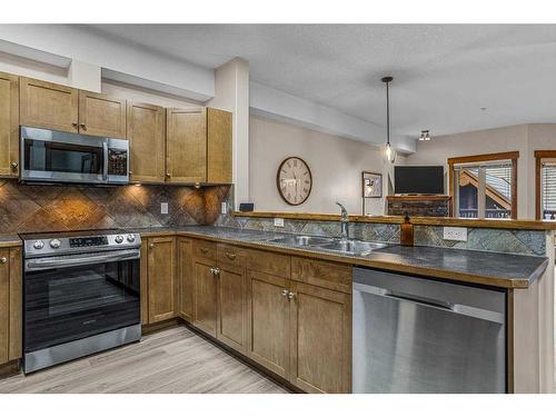 204-155 Crossbow Place, Canmore, AB - Indoor Photo Showing Kitchen With Double Sink