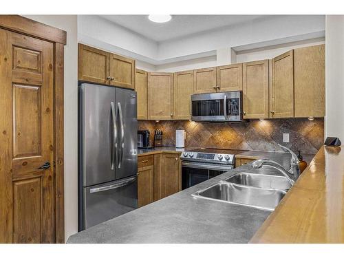 204-155 Crossbow Place, Canmore, AB - Indoor Photo Showing Kitchen With Double Sink