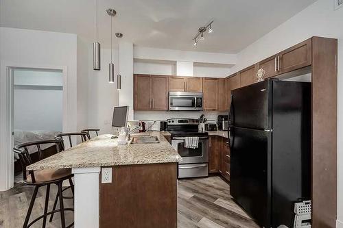 2115-604 East Lake Boulevard Se, Airdrie, AB - Indoor Photo Showing Kitchen With Stainless Steel Kitchen With Double Sink