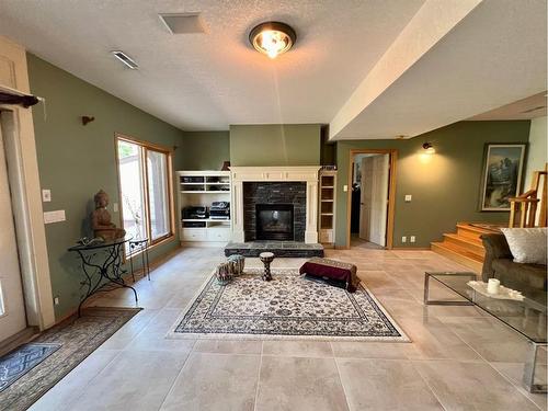 11 Black Bear, Rural Foothills County, AB - Indoor Photo Showing Living Room With Fireplace