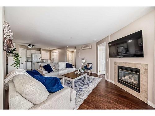 307-270 Shawville Way Se, Calgary, AB - Indoor Photo Showing Living Room With Fireplace