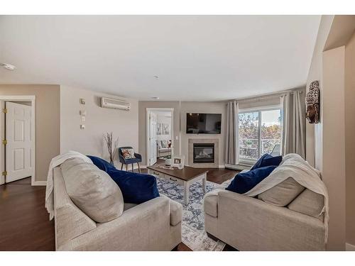 307-270 Shawville Way Se, Calgary, AB - Indoor Photo Showing Living Room With Fireplace