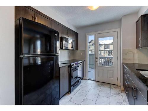 14 Windstone Green Sw, Airdrie, AB - Indoor Photo Showing Kitchen With Double Sink