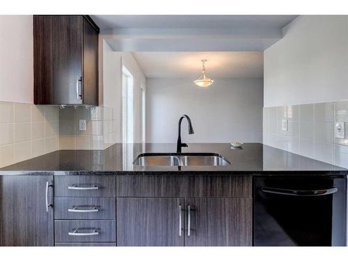 14 Windstone Green Sw, Airdrie, AB - Indoor Photo Showing Kitchen With Double Sink With Upgraded Kitchen