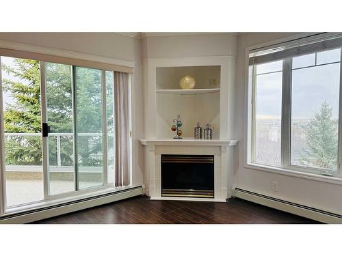 310-108 Edgeridge Terrace Nw, Calgary, AB - Indoor Photo Showing Living Room With Fireplace