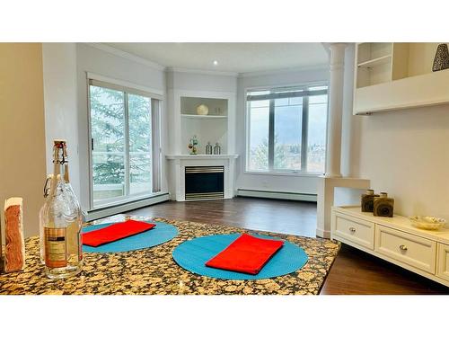 310-108 Edgeridge Terrace Nw, Calgary, AB - Indoor Photo Showing Living Room With Fireplace