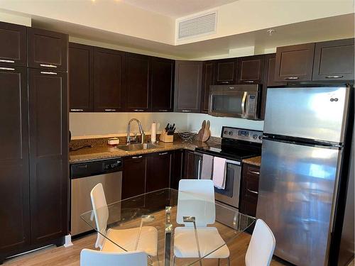 911-3830 Brentwood Road Nw, Calgary, AB - Indoor Photo Showing Kitchen With Stainless Steel Kitchen With Double Sink