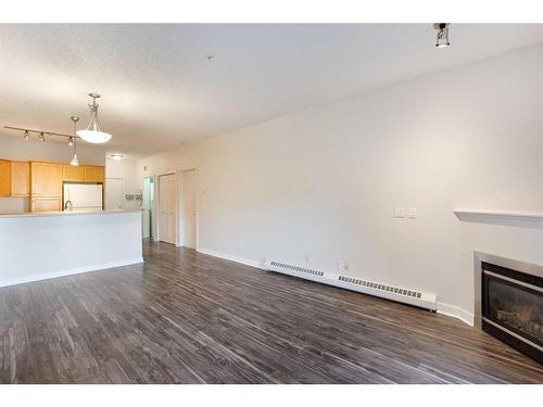 205-1414 17 Street Se, Calgary, AB - Indoor Photo Showing Kitchen With Fireplace