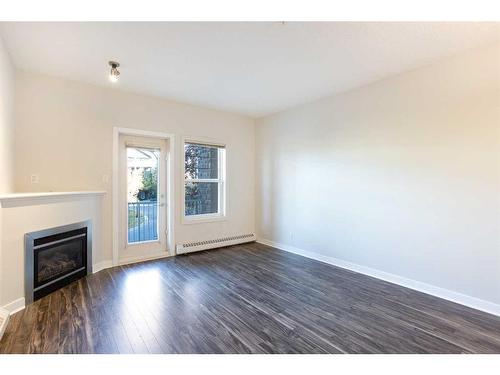 205-1414 17 Street Se, Calgary, AB - Indoor Photo Showing Living Room With Fireplace