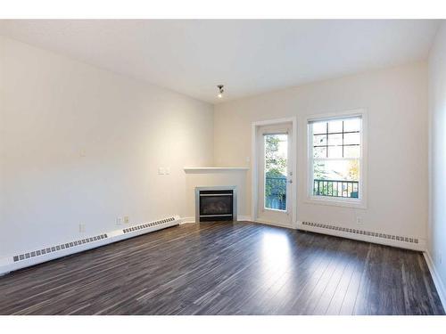 205-1414 17 Street Se, Calgary, AB - Indoor Photo Showing Living Room With Fireplace