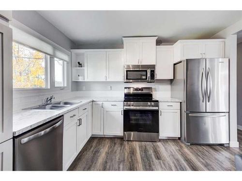 64 Healy Drive Sw, Calgary, AB - Indoor Photo Showing Kitchen With Double Sink