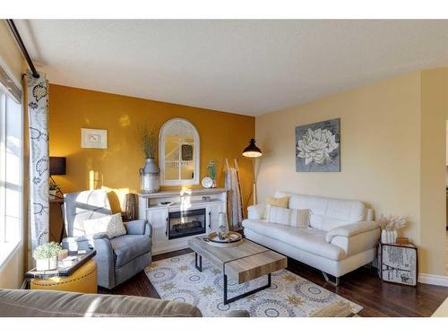 67 Taravista Gardens Ne, Calgary, AB - Indoor Photo Showing Living Room With Fireplace