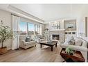 87 Cranbrook Way Se, Calgary, AB  - Indoor Photo Showing Living Room With Fireplace 