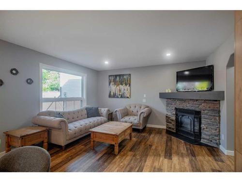 1035 Tuscany Drive Nw, Calgary, AB - Indoor Photo Showing Living Room With Fireplace