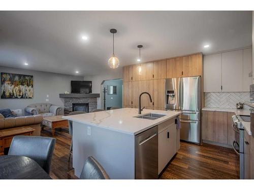 1035 Tuscany Drive Nw, Calgary, AB - Indoor Photo Showing Kitchen With Fireplace With Double Sink With Upgraded Kitchen