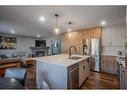 1035 Tuscany Drive Nw, Calgary, AB  - Indoor Photo Showing Kitchen With Fireplace With Double Sink With Upgraded Kitchen 