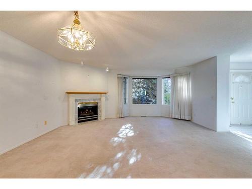 28 Richelieu Court Sw, Calgary, AB - Indoor Photo Showing Living Room With Fireplace