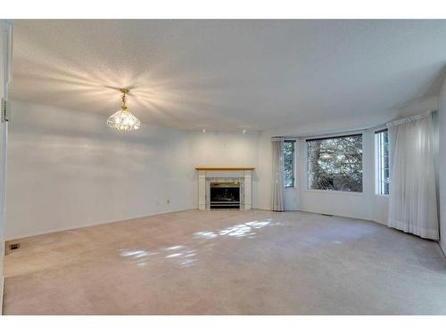 28 Richelieu Court Sw, Calgary, AB - Indoor Photo Showing Living Room With Fireplace