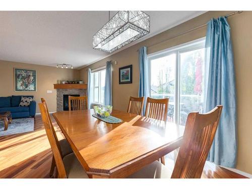 1152 Harvest Hills Drive Ne, Calgary, AB - Indoor Photo Showing Dining Room With Fireplace