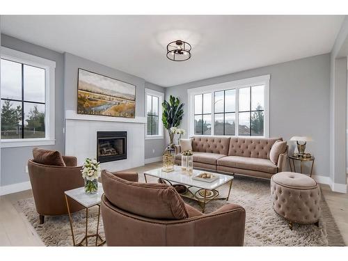 1209 Coopers Drive Sw, Airdrie, AB - Indoor Photo Showing Living Room With Fireplace