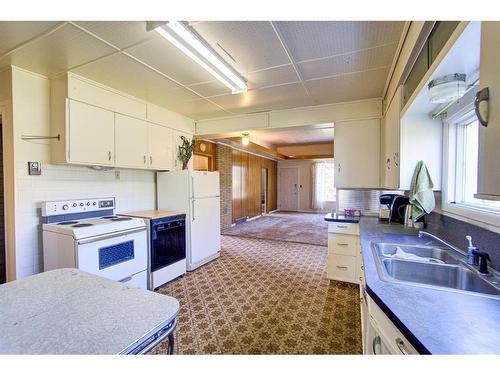 4530 2 Street East, Claresholm, AB - Indoor Photo Showing Kitchen With Double Sink