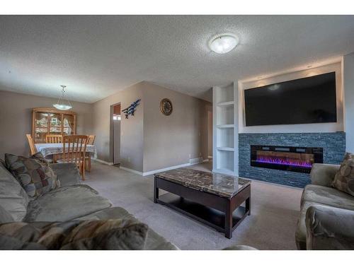 6527 23 Avenue Ne, Calgary, AB - Indoor Photo Showing Living Room With Fireplace