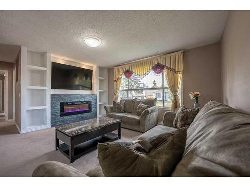 6527 23 Avenue Ne, Calgary, AB - Indoor Photo Showing Living Room With Fireplace