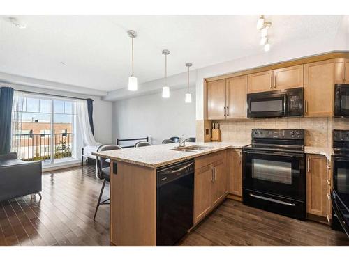 304-102 Cranberry Park Se, Calgary, AB - Indoor Photo Showing Kitchen With Double Sink