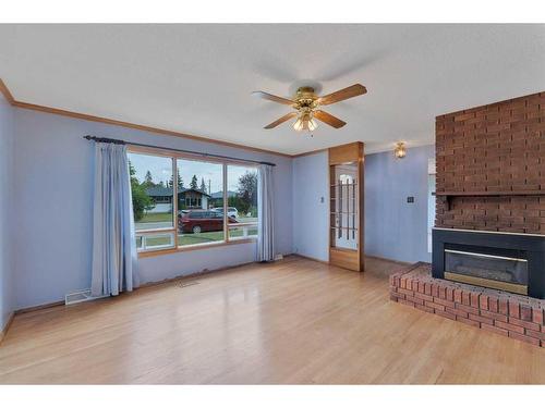 9831 Alcott Road Se, Calgary, AB - Indoor Photo Showing Living Room With Fireplace