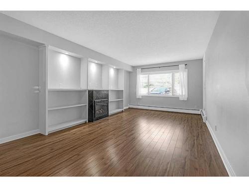 104-716 3 Avenue Nw, Calgary, AB - Indoor With Fireplace