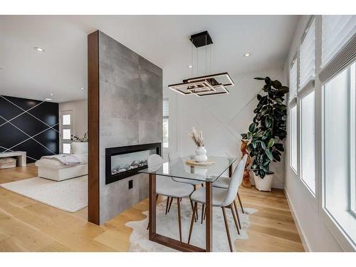 9135 Allison Drive Se, Calgary, AB - Indoor Photo Showing Dining Room With Fireplace