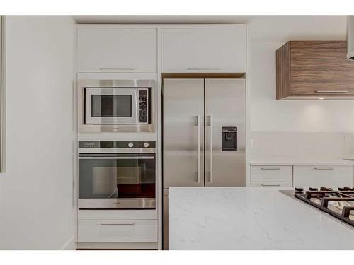 802-1087 2 Avenue Nw, Calgary, AB - Indoor Photo Showing Kitchen With Stainless Steel Kitchen