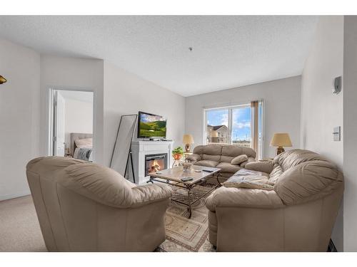 1315-1140 Taradale Drive Ne, Calgary, AB - Indoor Photo Showing Living Room With Fireplace