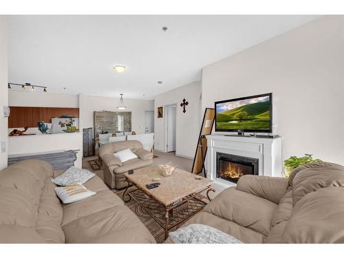 1315-1140 Taradale Drive Ne, Calgary, AB - Indoor Photo Showing Living Room With Fireplace