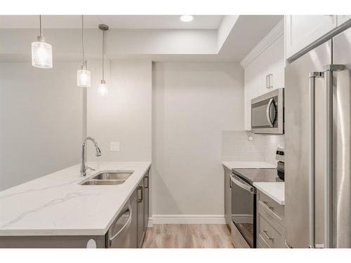 207-19661 40 Street Se, Calgary, AB - Indoor Photo Showing Kitchen With Double Sink With Upgraded Kitchen