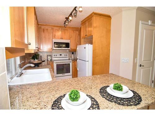 #402,-4554 Valiant Drive Nw, Calgary, AB - Indoor Photo Showing Kitchen With Double Sink