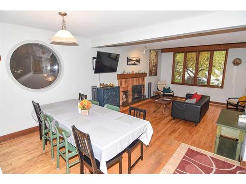 2535 7 Avenue Nw, Calgary, AB - Indoor Photo Showing Dining Room With Fireplace