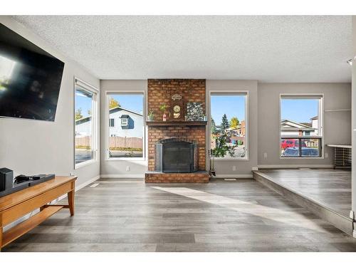 7 Templeson Road Ne, Calgary, AB - Indoor Photo Showing Living Room With Fireplace