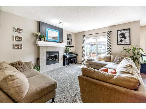 1362 Bayside Drive Sw, Airdrie, AB - Indoor Photo Showing Living Room With Fireplace