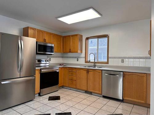 148 Mt Allan Circle Se, Calgary, AB - Indoor Photo Showing Kitchen With Double Sink