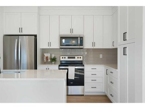 321 Baneberry Way Sw, Airdrie, AB - Indoor Photo Showing Kitchen With Upgraded Kitchen