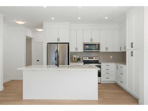 321 Baneberry Way Sw, Airdrie, AB - Indoor Photo Showing Kitchen With Upgraded Kitchen