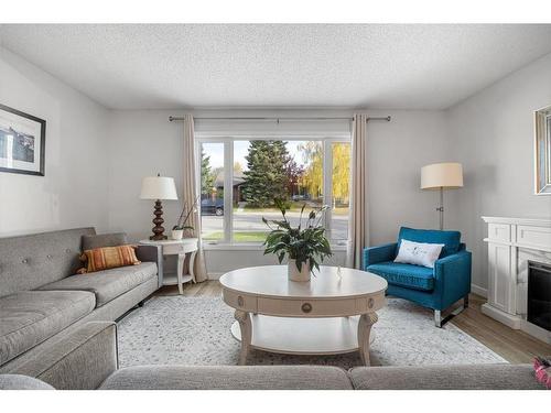 91 Midglen Way Se, Calgary, AB - Indoor Photo Showing Living Room With Fireplace