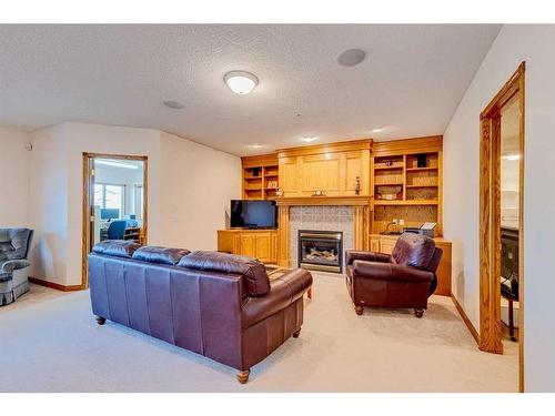 15 Taylor Bay, Rural Rocky View County, AB - Indoor Photo Showing Living Room With Fireplace