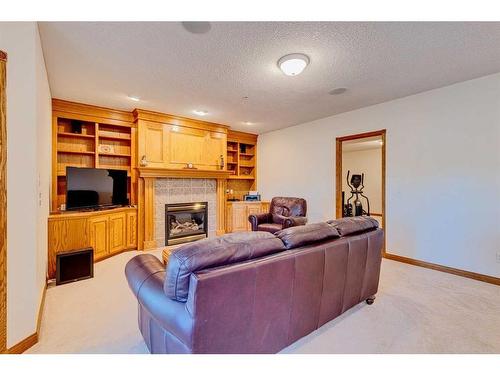 15 Taylor Bay, Rural Rocky View County, AB - Indoor Photo Showing Living Room With Fireplace