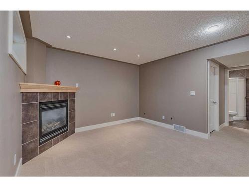 3 Evergreen Square Sw, Calgary, AB - Indoor With Fireplace